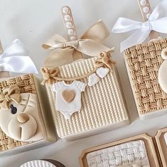 baby shower items displayed on white table with bows and ribbon around the edges, including teddy bear cookies