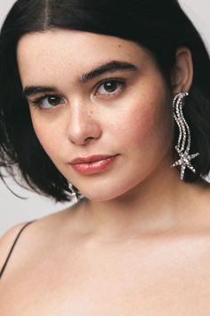 a close up of a person wearing earrings