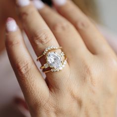 a woman's hand with a ring on it and a diamond in the middle