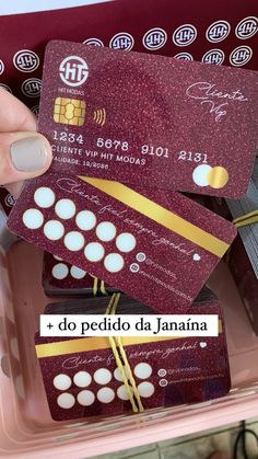 someone is holding up their credit cards in a plastic container with the words do pedilo da janina on it