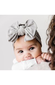 a baby with a big bow on her head