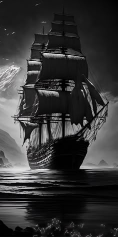 a black and white photo of a pirate ship in the ocean with mountains in the background