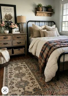 a bed sitting next to a window in a bedroom