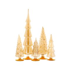 small glass christmas trees are lined up against a white background