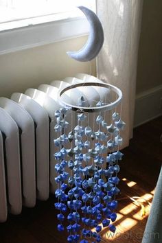 a wind chime next to a radiator with a crescent hanging from it