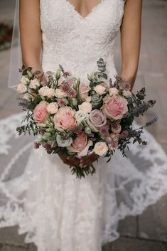 a bride holding a bouquet of flowers in her hands