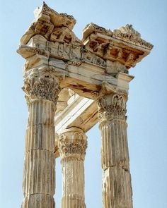 an ancient building with two columns and carvings