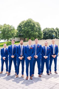 a group of men in blue suits standing next to each other