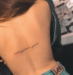 a woman's lower back tattoo with the words, love and life written on it