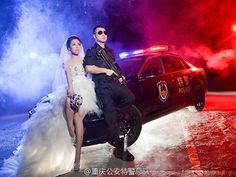 a man and woman standing next to a police car