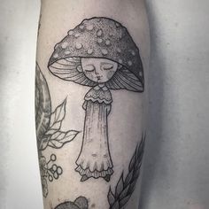 a black and white tattoo with a mushroom on it