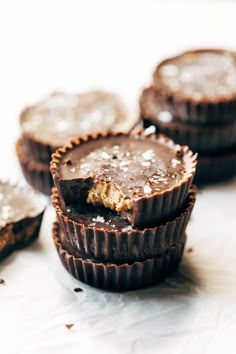 several chocolate cups are stacked on top of each other with sea salt in the middle