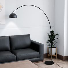 a living room with a black couch and a floor lamp