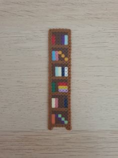 an object made out of beads on top of a wooden table