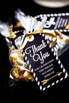 a thank you bag filled with chocolates on top of a black tablecloth covered table