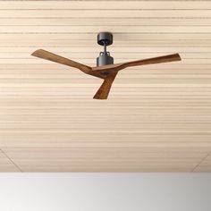 a ceiling fan mounted to the side of a wooden ceiling