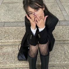 a woman sitting on the steps covering her mouth