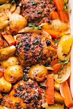 chicken, potatoes and carrots in a white casserole dish with parsley