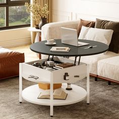 a living room with a couch, coffee table and laptop on it's stand