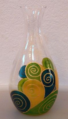 a glass vase with swirls painted on it