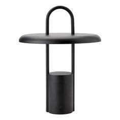 an outdoor table with a round top and black metal base, on a white background