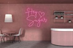 a pink wall with the words happy suga written in cursive writing on it