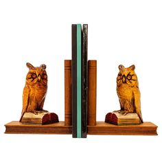 an owl bookend is sitting on top of a bookshelf with two owls