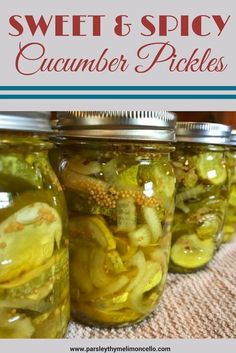 jars filled with pickles sitting on top of a table next to the words sweet & spicy cucumber pickles