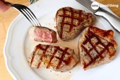 three waffles on a white plate with fork and knife