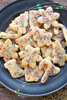 a plate full of sugar cookies with sprinkles