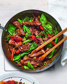 a pan filled with meat and veggies on top of a table