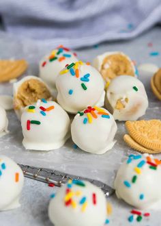 six donuts with white frosting and sprinkles