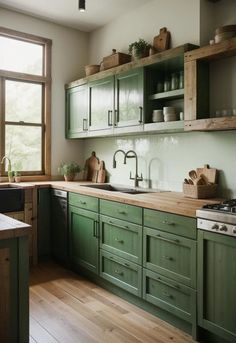 a kitchen filled with lots of green cabinets and counter top space next to a window