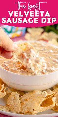 the best velveeta sausage dip is in a white bowl with tortilla chips