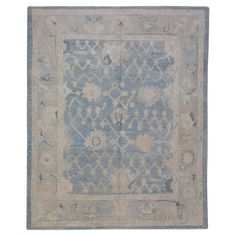 an antique rug with blue and beige colors