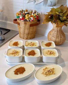 there are many bowls with food in them on the counter