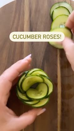 someone cutting cucumbers on a wooden board with the words cucumber roses