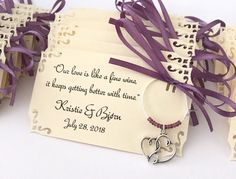 wedding favors with purple ribbon tied around them and two tags attached to the back of them