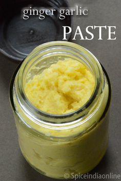 a jar filled with yellow paste sitting on top of a table