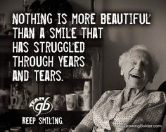 an old woman sitting at a table with a quote on it that says, nothing is more beautiful than a smile that has struggle through years and tears