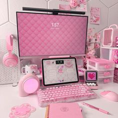 a pink desk with a laptop, keyboard and mouse