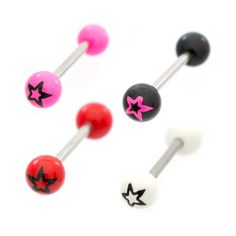 three different colored balls with black stars on them and one pink star in the middle