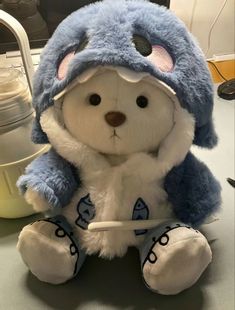 a blue and white stuffed animal sitting on top of a table