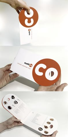 two hands holding an open brochure with the letter c on it, and another person's hand reaching out