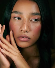 a woman with freckles on her face and hands