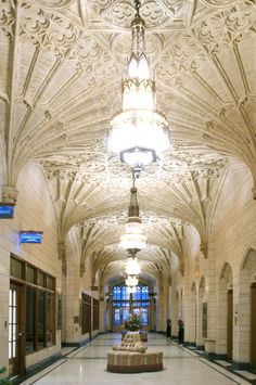 an ornately decorated hallway with chandelier and marble floors