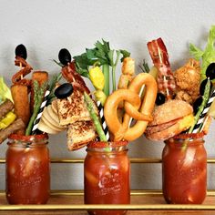 three mason jars filled with food on top of a wooden shelf