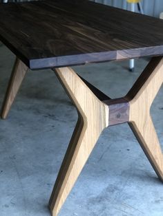 a wooden table sitting on top of a cement floor