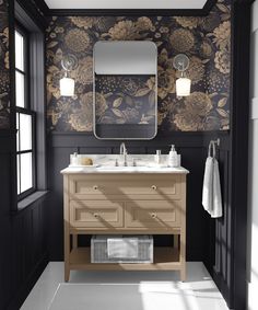 a bathroom with black and gold wallpaper, two sinks and a large mirror above it