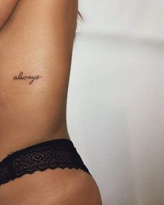 a woman's stomach with the word always tattooed on her left side ribcage